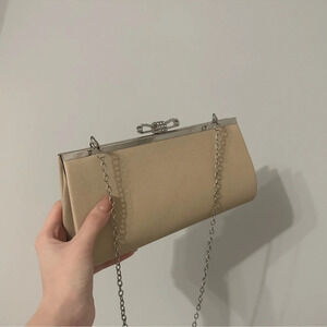 Cream clutch bag with a shoulder strap